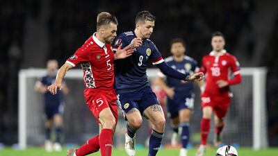Lyndon Dykes (in blue) battles for possession with Maxim Potirniche of Moldova. Getty Images