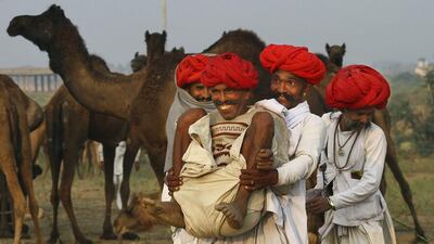 Indian camel herders play around during the annual cattle fair in Pushkar, Rajasthan state, India. Deepak Sharma / AP