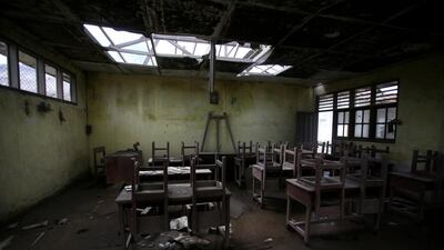 Chairs rest on tables in an empty classroom at an elementary school in the abandoned village of Simacem, North Sumatra, Indonesia. The village was abandoned after its people were evacuated following the eruption of Mount Sinabung. Binsar Bakkara / AP Photo
