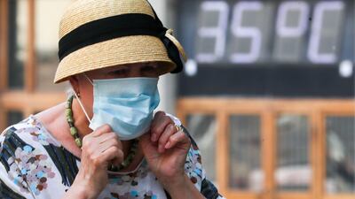 A woman wears a face mask during a heatwave in central Moscow. Getty Images