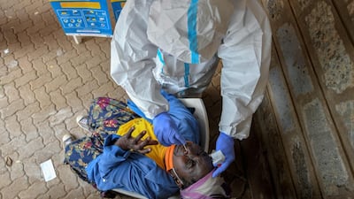 A woman reacts to a nasal swab during a free testing for Covid-19 in the Kibera slum in Nairobi. The Nairobi Metropolitan Services started a free coronavirus mass testing programme across Nairobi for two days following a surge in cases around the country. AFP