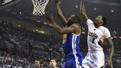 Draymond Green of the Golden State Warriors drive to the basket on Al-Farouq Aminu of the Portland Trail Blazers during the first quarter of Game 4 of the Western Conference semi-finals during the 2016 NBA Play-offs at the Moda Center on May 9, 2016 in Portland, Oregon. Steve Dykes/Getty Images/AFP