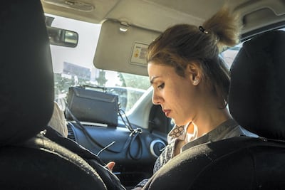 Lamiaa Alnasiry jots down a poem on her phone. "if I were in prison I would have more freedom, because here we must always follow what the community wants, especially in love," she says. Arianna Pagani for The National