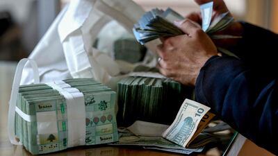 A clerk counts Lebanese pounds at a currency exchange office in Beirut. AFP