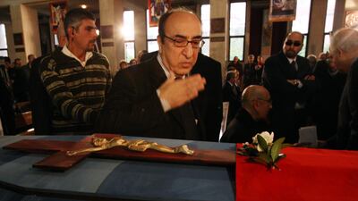 Elias Rahbani bids farewell to his late brother, composer Mansour Rahbani, as he walks past his coffin during his funeral at a church in Antelias, a northern suburb of Beirut in 2009. AFP