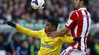 Stoke City's Erik Pieters, right, challenges Arsenal's Alex Oxlade-Chamberlain during their match. Darren Staples / Reuters