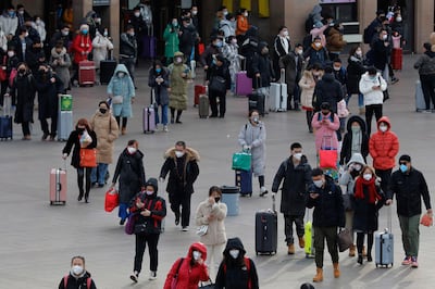 Chinese people wear masks as they arrive at Beijing Railway Station in the Chinese capital. EPA