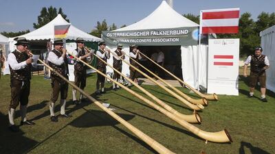 Austrian falconers play the alphorn at the 3rd International Festival of Falconry at Al Forsan International Sports Resort in Abu Dhabi.
