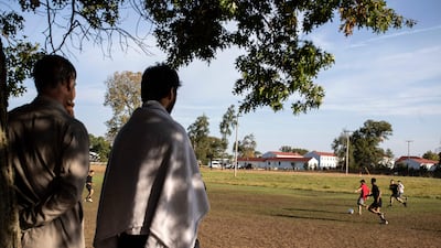 Members of the US military and Afghan refugees play football at the Fort McCoy army base, in Wisconsin. The White House has announced three new categories through which Afghans can be resettled. AFP