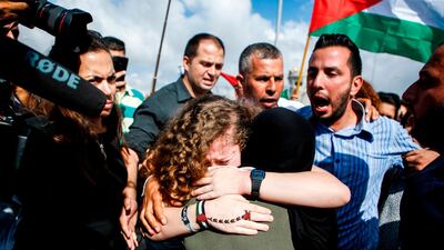 Palestinian activist and campaigner Ahed Tamimi is seen embracing a woman after he release from prison after an eight-month sentence for slapping two Israeli soldiers, in the West Bank village of Nabi Saleh. Abbas Momani/AFP