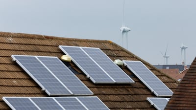 Solar energy panels and wind turbines in Burton Latimer, England, as Europeans try to cut energy use. Reuters