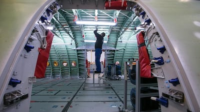 An employee inspects the interior of the upper passenger deck of an Airbus A380 in Hamburg. Bloomberg