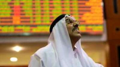 A trader watches as shares at the Dubai Financial Market climb.