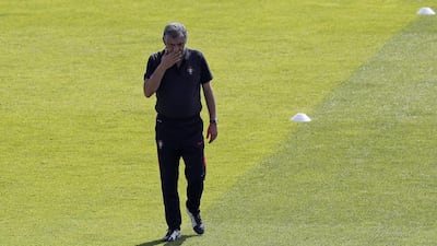 Portugal coach Fernando Santos walks on the pitch during a training session, in preparation of the Euro 2016 final soccer match between France and Portugal, at Marcoussis, south of Paris, France, Friday, July 8, 2016. (AP Photo/Francois Mori)