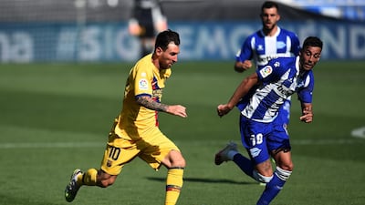 Lionel Messi runs with the ball under pressure from Victor Camarasa. Getty Images
