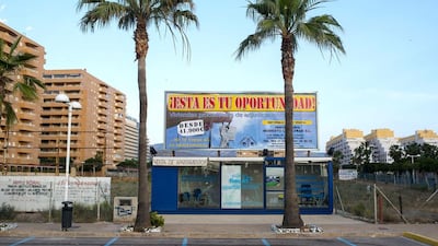 A closed stall of a real estate developer sits next to an empty plot of land in the Marina d’Or resort. David Ramos / Getty Images