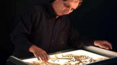 The sand animator Ferenc Cakó, preparing an installation piece.