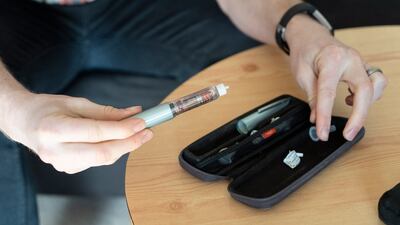 A diabetic prepares his insulin injection. AFP