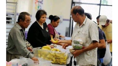 People pick up lunch in the soup kitchen of the St Francis Centre in Los Angeles. Kevork Djansezian / Getty