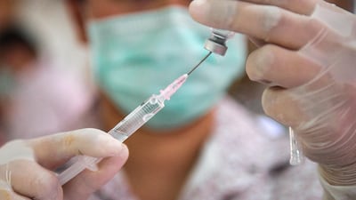 A health worker prepares a dose of a Covid-19 vaccine. Reuters