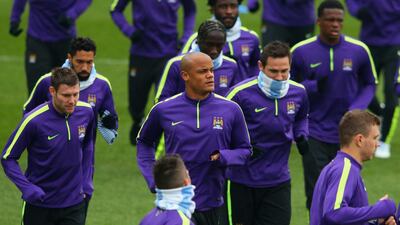 City captain Kompany leads his team in a jog alongside James Milner, left, and Frank Lampard, right. Alex Livesey / Getty Images