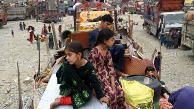 Afghan refugees arrive with their belongings on trucks from Pakistan at the Afghanistan-Pakistan border. Thousands faced the threat of detention and deportation on November 1. AFP