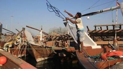 A crewman moors his dhow at the Abu Dhabi fishing harbour. Ravindranath K / The National