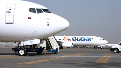 A flydubai plane on the tarmac at Terminal 2 of the Dubai International Airport. Low-cost carriers (LCCs) in the region increased their capacity by 17.7 per cent in the 12 months ending in June. Randi Sokoloff / The National