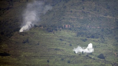 Smoke rises following alleged shelling by Indian troops in the Nakial Sector of Pakistan-administered Kashmir on August 18. Sajjad Qayyum / AFP
