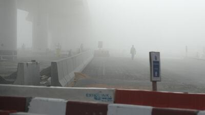 Workers working at the Expo 2020 metro line during the early morning fog in Discovery Gardens and Al Furjan area in Dubai. Pawan Singh / The National