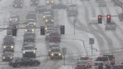 Vehicles travel in blizzard conditions on Dodge Street in Omaha, Nebraska, yesterday.