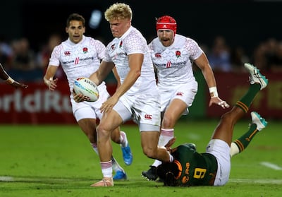 DUBAI, UNITED ARAB EMIRATES - DECEMBER 06: Ben Harris of England is tackled by Justin Geduld of South Africa during the match between England and South Africa on Day Two of the HSBC World Rugby Sevens Series - Dubai at The Sevens Stadium on December 06, 2019 in Dubai, United Arab Emirates. (Photo by Francois Nel/Getty Images)