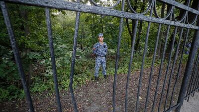 Russian policemen stand guard during the funeral. EPA