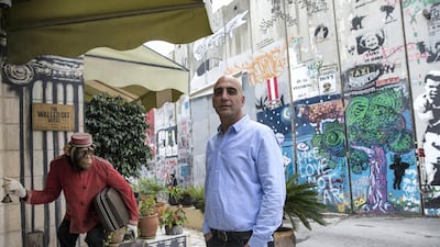 Co-founder Wissam Salsa stands at the entrance of the Walled Off Hotel, which has attracted more than 60,000 visitors since March this year, helping the tourism industry in Palestine go from strength to strength. Heidi Levine for The National