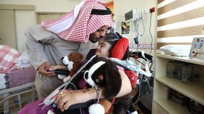 AL AIN , UNITED ARAB EMIRATES – Aug 3 , 2014 : Sayeed Al Amiri greeting his daughter Alia Al Amiri ( 12 years old ) at Amana Healthcare , a long term care facility in Al Shoiaba area in Al Ain . ( Pawan Singh / The National ) For News. Story by Jennifer Bell