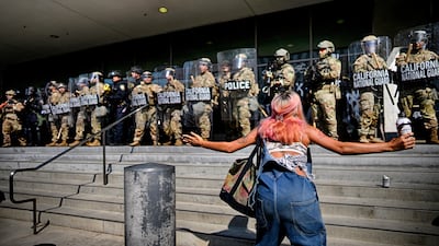 A protester approaches National Guard troops in downtown Los Angeles. AP