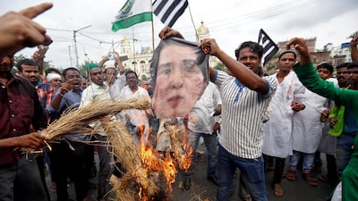 Protesters in Kolkata burn an effigy depicting Aung San Suu Kyi during a rally against what they say are killings of Rohingya people in Myanmar