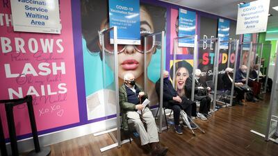 People wait to receive the Oxford/AstraZeneca vaccine at a Superdrug pharmacy in Guildford. Reuters