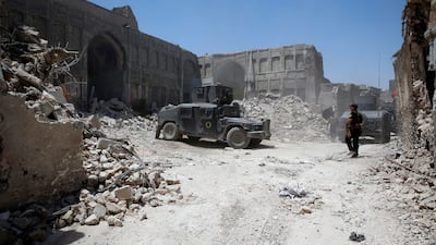 A member of the Iraqi forces stands guard next to armoured vehicles at the frontline in Mosul's Old City on June 27, 2017. Erik De Castro / Reuters