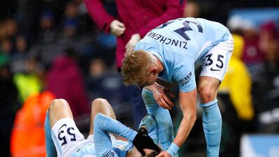 Manchester City's Oleksandr Zinchenko checks on injured team mate Brahim Diaz. Jason Cairnduff / Reuters