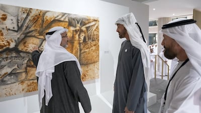 Sheikh Mohamed bin Zayed speaks with an artist while visiting the Qasr Al Hosn Festival.