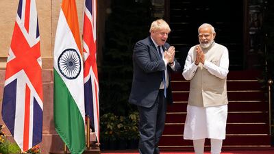 Britain's Prime Minister Boris Johnson (L) and his Indian counterpart Narendra Modi bond before their meeting at Hyderabad House in New Delhi. AFP