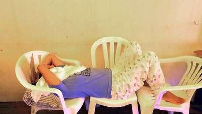 A woman sleeps at the Filipino Workers Resource Centre in Abu Dhabi.