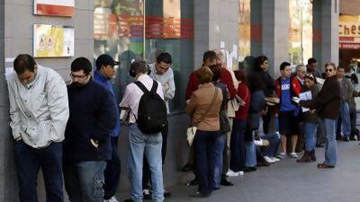 People queue to enter a government-run employment office in Madrid. Spain’s unemployment rate rose to a new record of 27.2 per cent in the first quarter of this year.