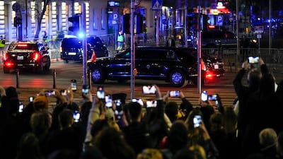 People take pictures as the motorcade with the US President arrives at the Marriot hotel in Warsaw. AP