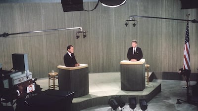John F Kennedy, pictured with Richard Nixon, changed how we understand politicians in the 1960s. AP Photo