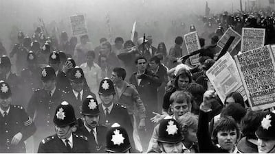 Police protect participants in a National Front march from left-wing demonstrators hurling missiles in the South London borough of Lewisham in 1977.