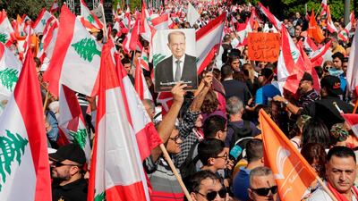 A supporter of Lebanon's President Michel Aoun holds his picture during a counter-protest near the presidential palace in Baabda in November. AFP