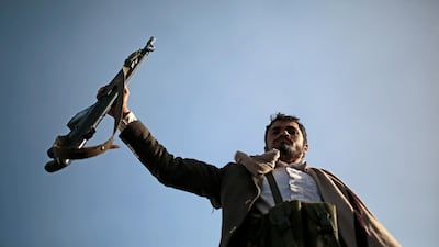 A Houthi supporter holds his weapon during a demonstration against the United States over its decision to designate the Houthis a foreign terrorist organization in Sanaa, Yemen. AP