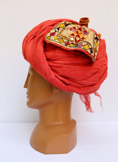 A red headgear with a smoking pipe, mirror, comb and tobacco pouch tucked in the headgear worn by the male members of Gawariya Nomadic tribe. Photo: Maharaja Fateh Singh Museum